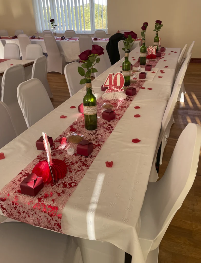 Long table with red and pink decoartions for a birthday party
